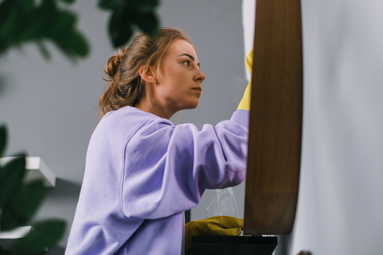 A Scent and Fresh cleaner polishing a wooden surface